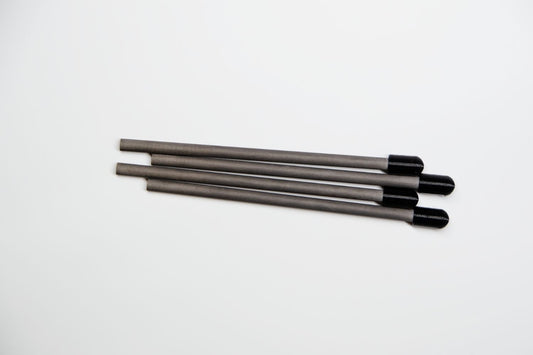 Four long, thin gray rods with black rounded ends, arranged diagonally on a plain white background.
