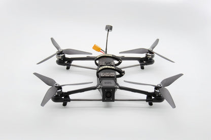 A black quadcopter drone with four gray propellers, shown from a top-down perspective on a clean white background.