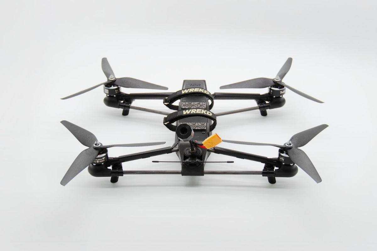 Black quadcopter drones with gray propellers, drone features a mounted camera 