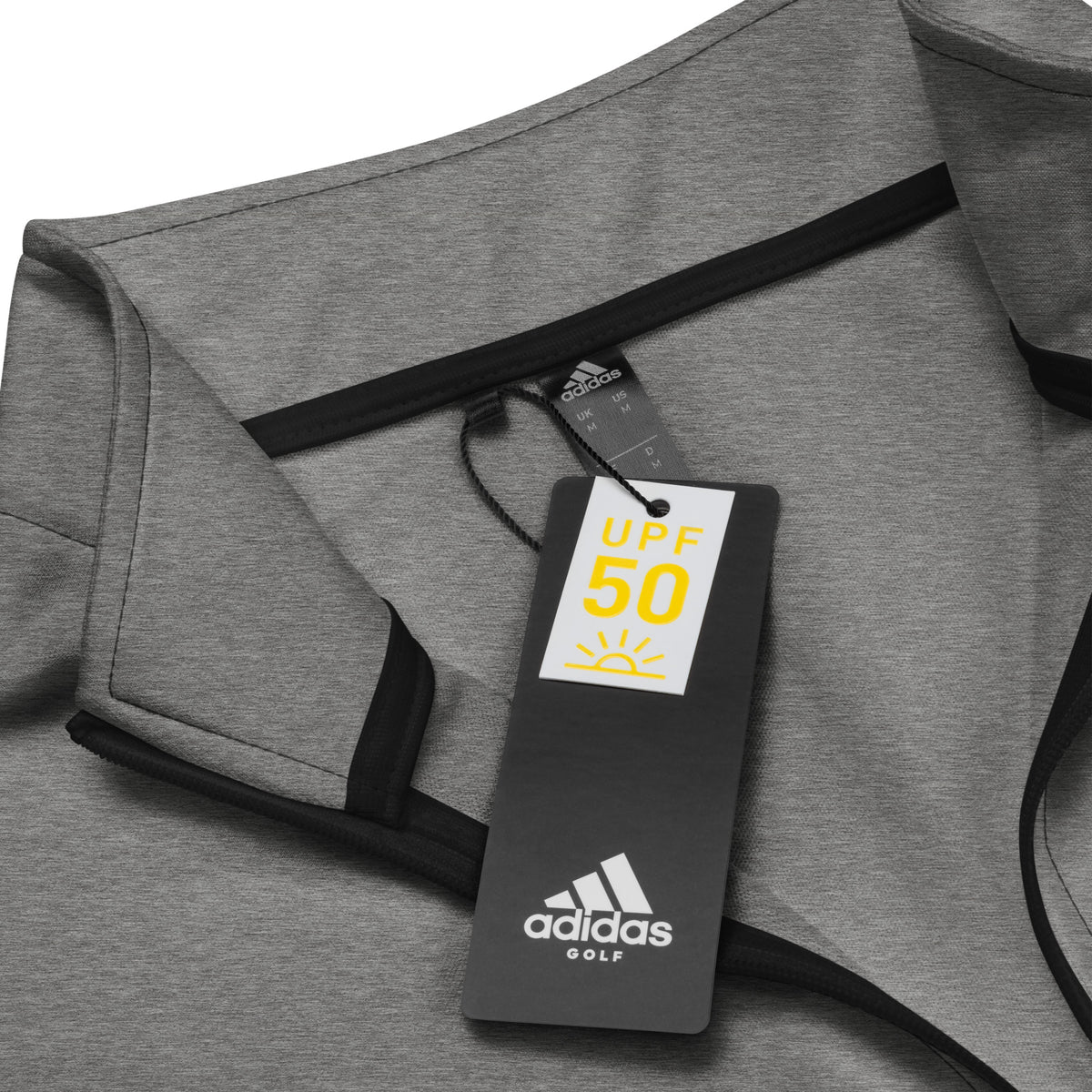 Gray Adidas quarter zip pullover with a UV protection tag on a white background