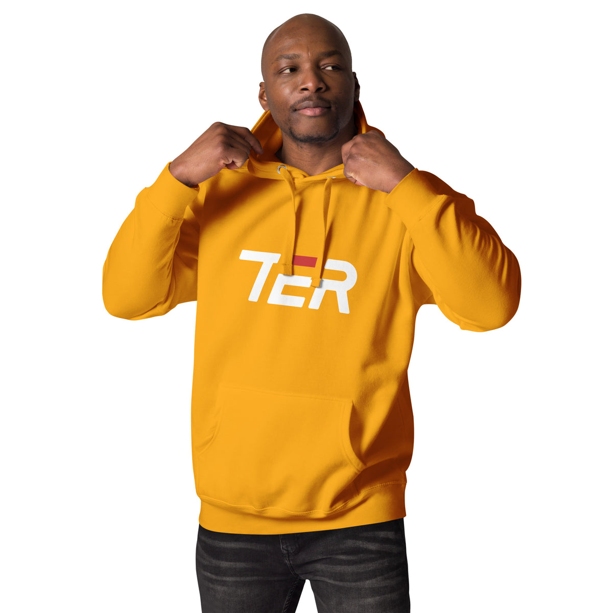 A man wearing a mustard yellow hoodie with a white and red 'TER' logo on the chest, posing with his hands on the hood against a solid white background.